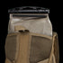 A Condor Hydration Backpack 8L in tan, featuring mesh detailing, has a tactical bladder with a black slider partially inserted into its back pocket.